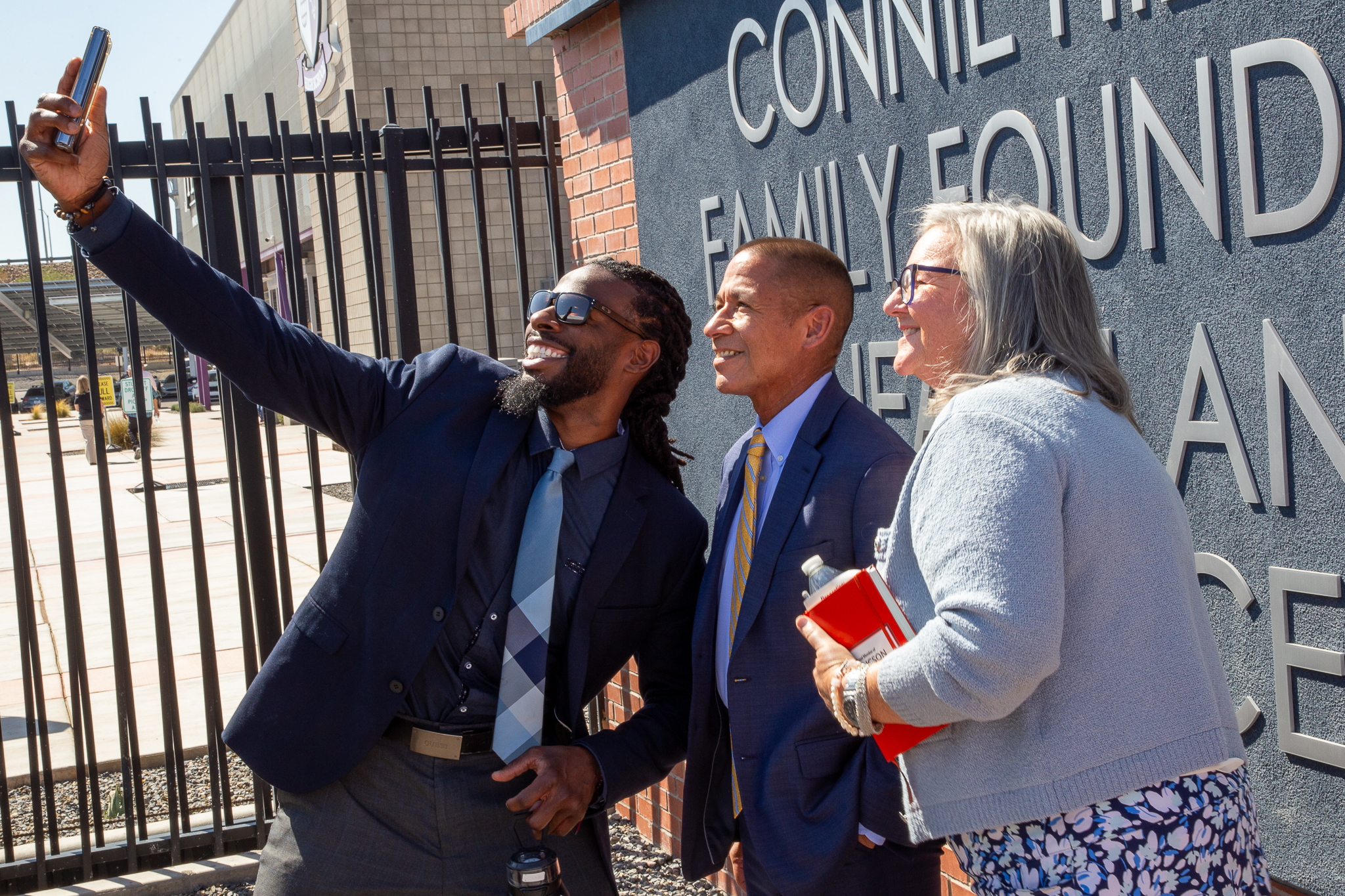 InTech teachers get a selfie with Superintendent Trujillo in front of the new sign