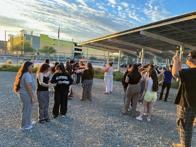 Seniors gather outside on campus to watch the sunrise