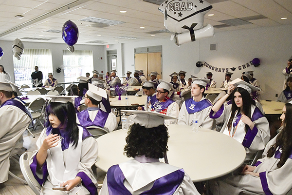 Graduates sit in the conference room before the ceremony