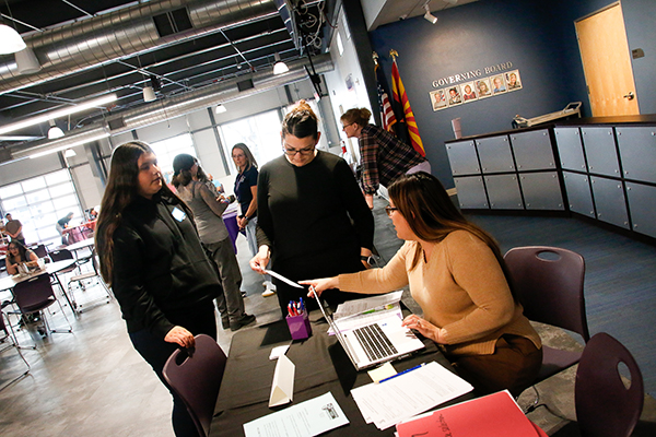 A teen girl checks in at the table