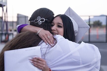 An InTech grad hugs one of her teachers