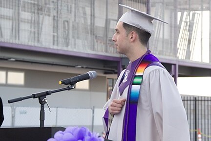 An InTech grad stands on the stage about to deliver his speech